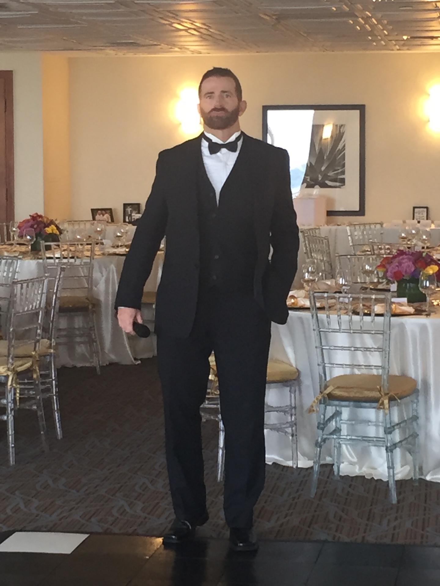 Johnny E hosting an event in a formal reception hall